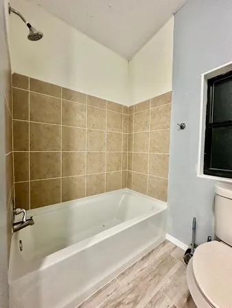 a bathroom with a bathtub and toilet