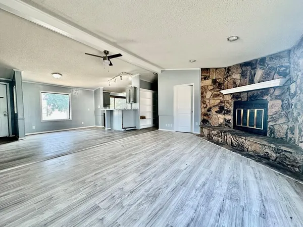 a view of a livingroom with a fireplace and window