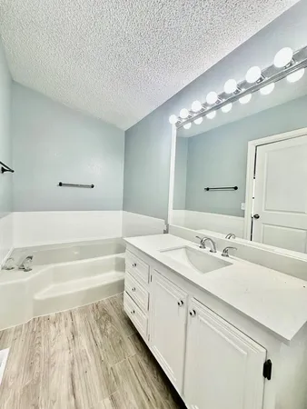 a spacious bathroom with a double vanity sink and a mirror