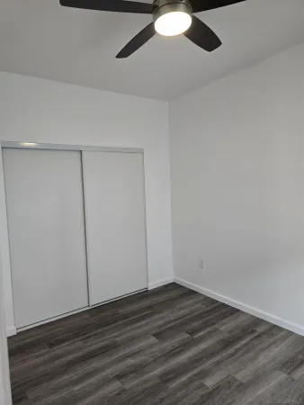 a view of a room with wooden floor