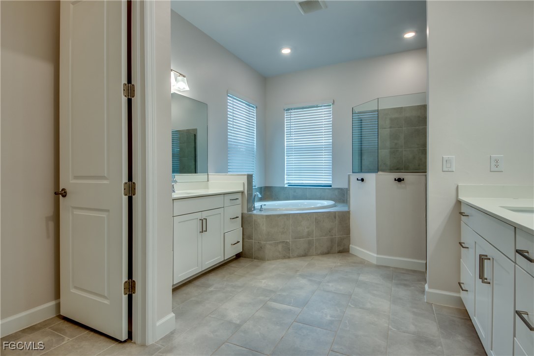 11674 Russet Trail Fort Myers, FL 33913 - Photo 15 of 47 a bathroom with a tub sink and mirror