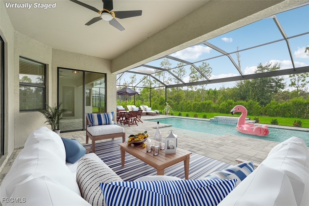 11674 Russet Trail Fort Myers, FL 33913 - Photo 21 of 47 a living room with patio a couch and a floor to ceiling window