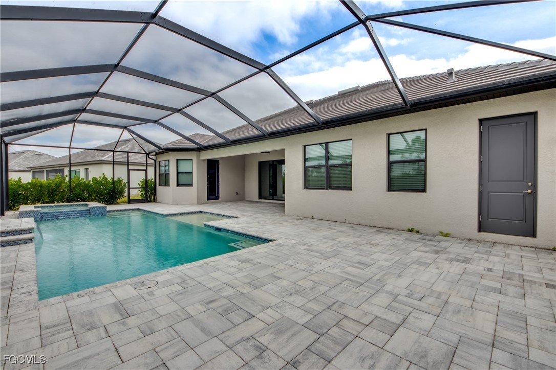 11674 Russet Trail Fort Myers, FL 33913 - Photo 25 of 47 a view of a patio with a table and chairs under an umbrella
