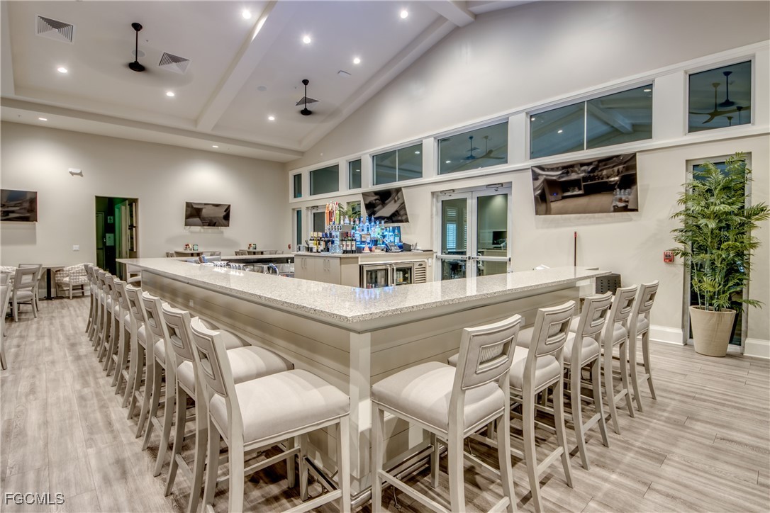 11674 Russet Trail Fort Myers, FL 33913 - Photo 47 of 47 a kitchen with stainless steel appliances kitchen island granite countertop a table and chairs in it