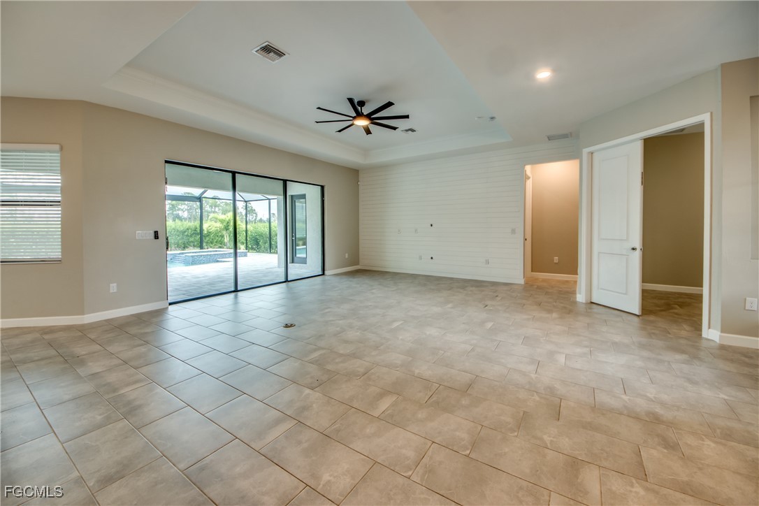 11674 Russet Trail Fort Myers, FL 33913 - Photo 6 of 47 an empty room with windows and ceiling fan