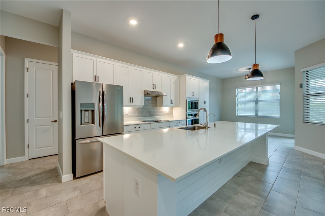 11674 Russet Trail Fort Myers, FL 33913 - Photo 10 of 47 a large kitchen with stainless steel appliances a refrigerator a sink and a stove