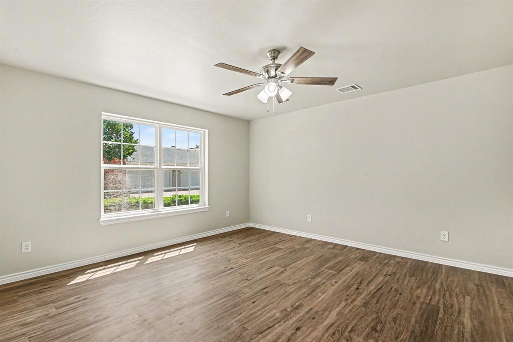 6113 Haley Lane Fort Worth, TX 76132 - Photo 18 of 38 Primary bedroom includes new luxury vinyl plank flooring, new ceiling fan.