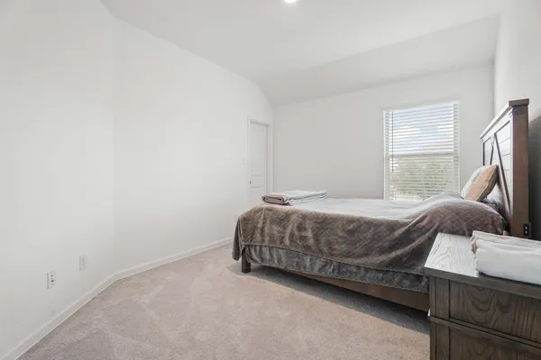 a bedroom with a bed and a couch