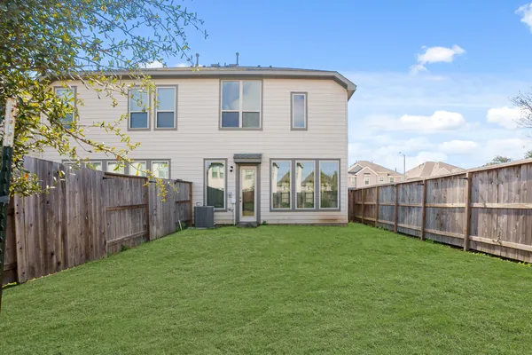 a view of a house with a yard and sitting area