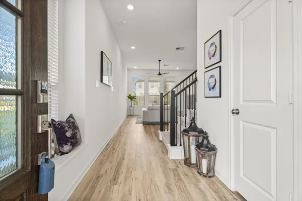 a view of entryway and hall with wooden floor