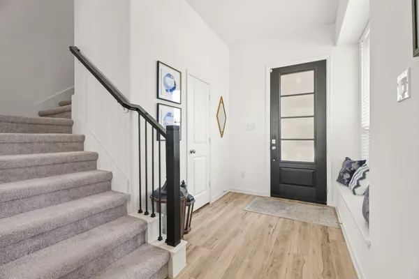 a view of a bedroom with wooden floor and stairs