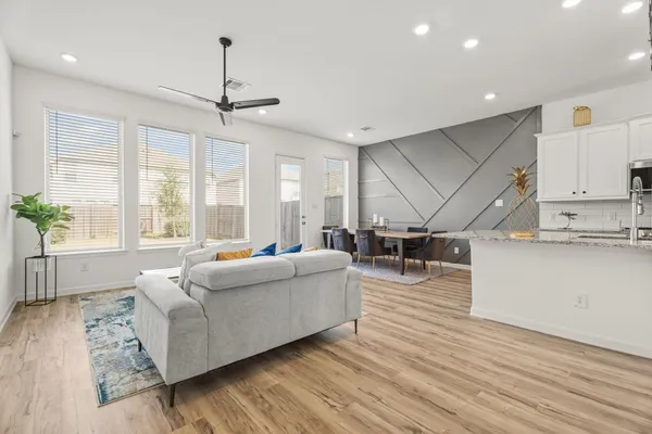 a living room with furniture and wooden floor
