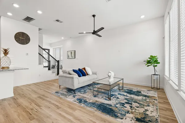 a living room with furniture and wooden floor