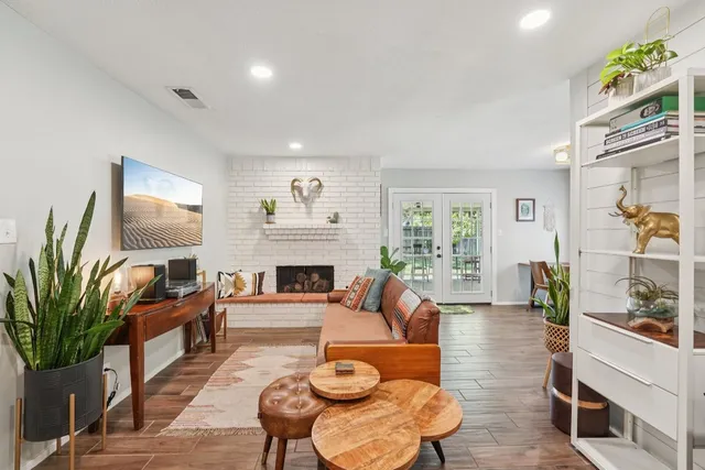 a living room with furniture fireplace and a potted plant