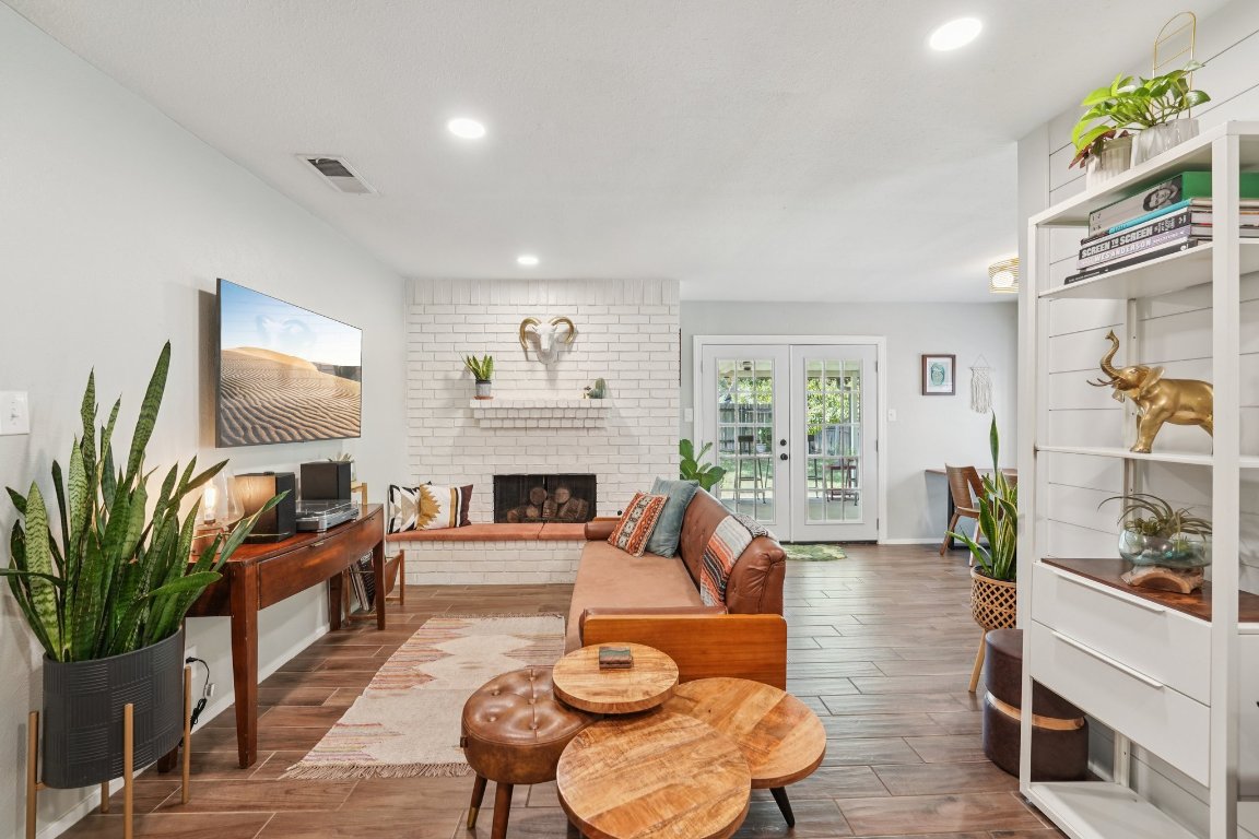 a living room with furniture fireplace and a potted plant