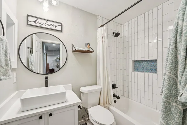 a bathroom with a toilet a sink and a shower