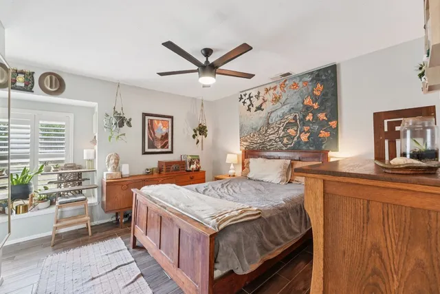 a bedroom with a large bed and a chandelier