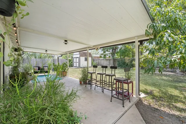 a view of a porch with chairs and backyard
