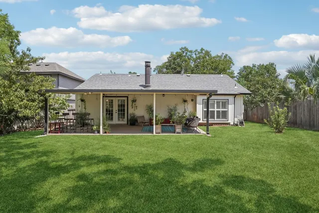 a view of a house with a yard and garden