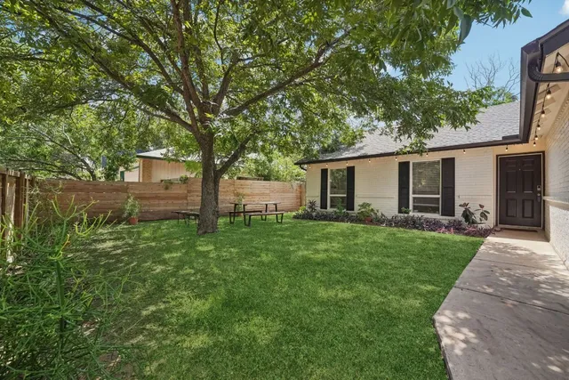 a front view of house with yard and green space