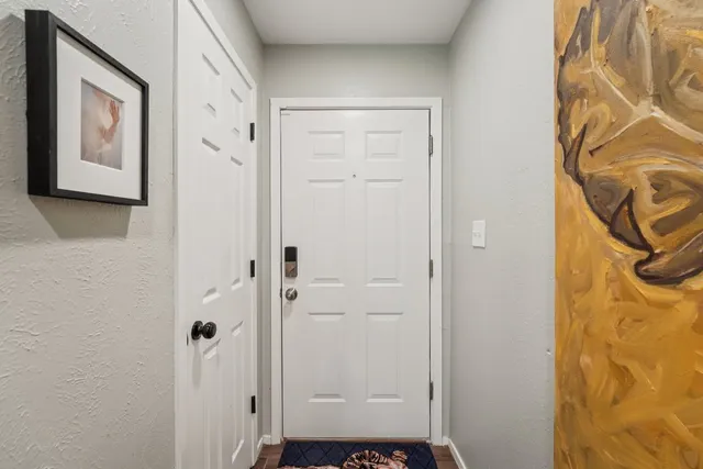 a view of a hallway with paintings on the wall