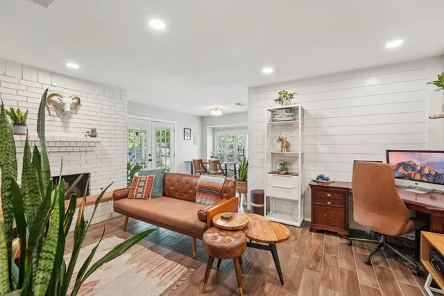 a living room with fireplace furniture and a wooden floor