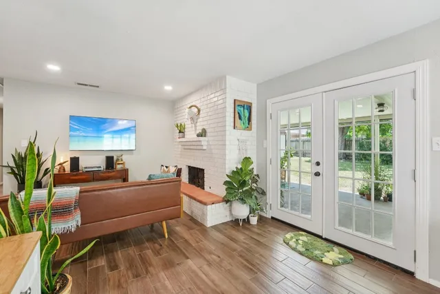 a living room with furniture and a potted plant