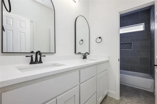 a bathroom with a double vanity sink and a mirror