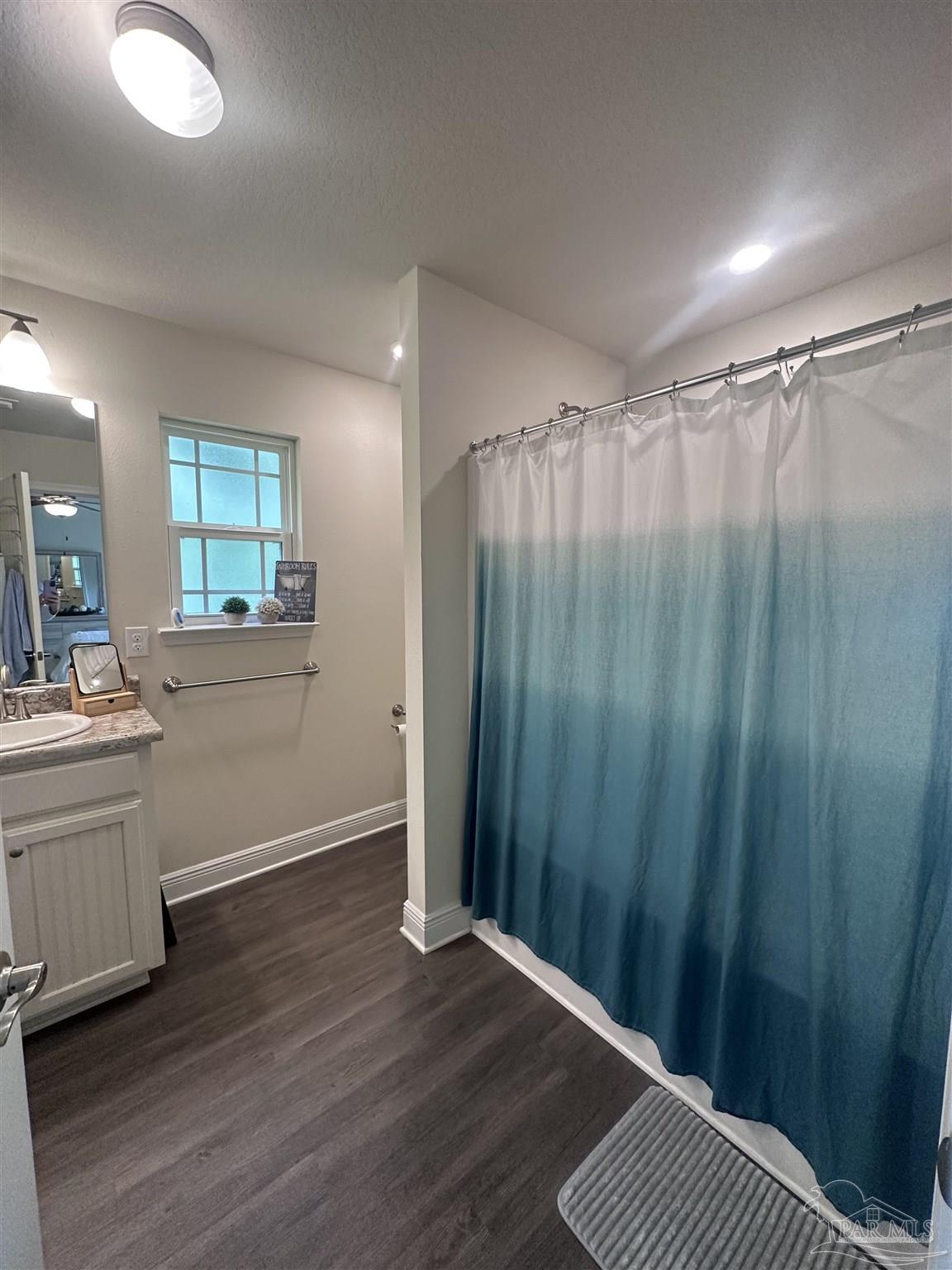 5217 Saufley Field Road Pensacola, FL 32526 - Photo 23 of 26 a view of a bathroom with double vanity and a shower