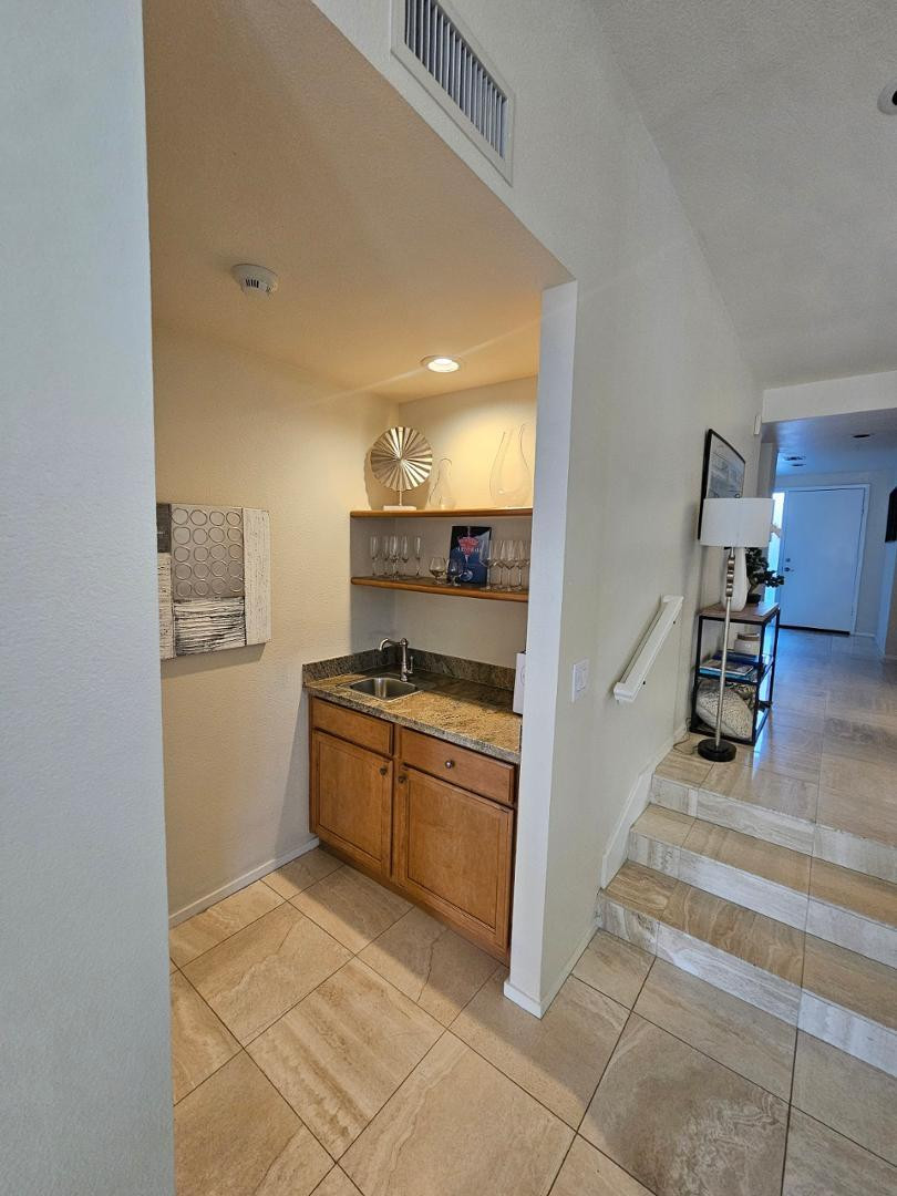 7700 East Gainey Ranch Road, Unit 153 Scottsdale, AZ 85258 - Photo 15 of 24 a kitchen with stainless steel appliances granite countertop a refrigerator and a sink