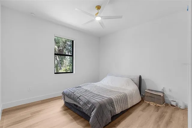 a bedroom with a bed and a window