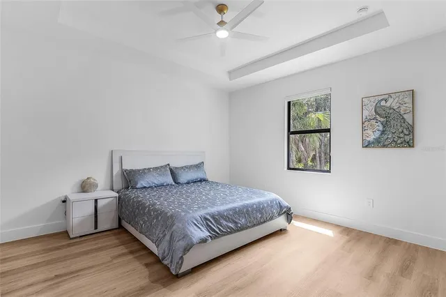 a bedroom with a bed and painting on the wall