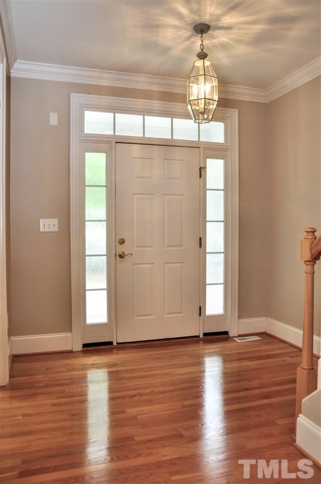 6902 Ray Road Raleigh, NC 27613 - Photo 2 of 23 a view of empty room with wooden floor and fan