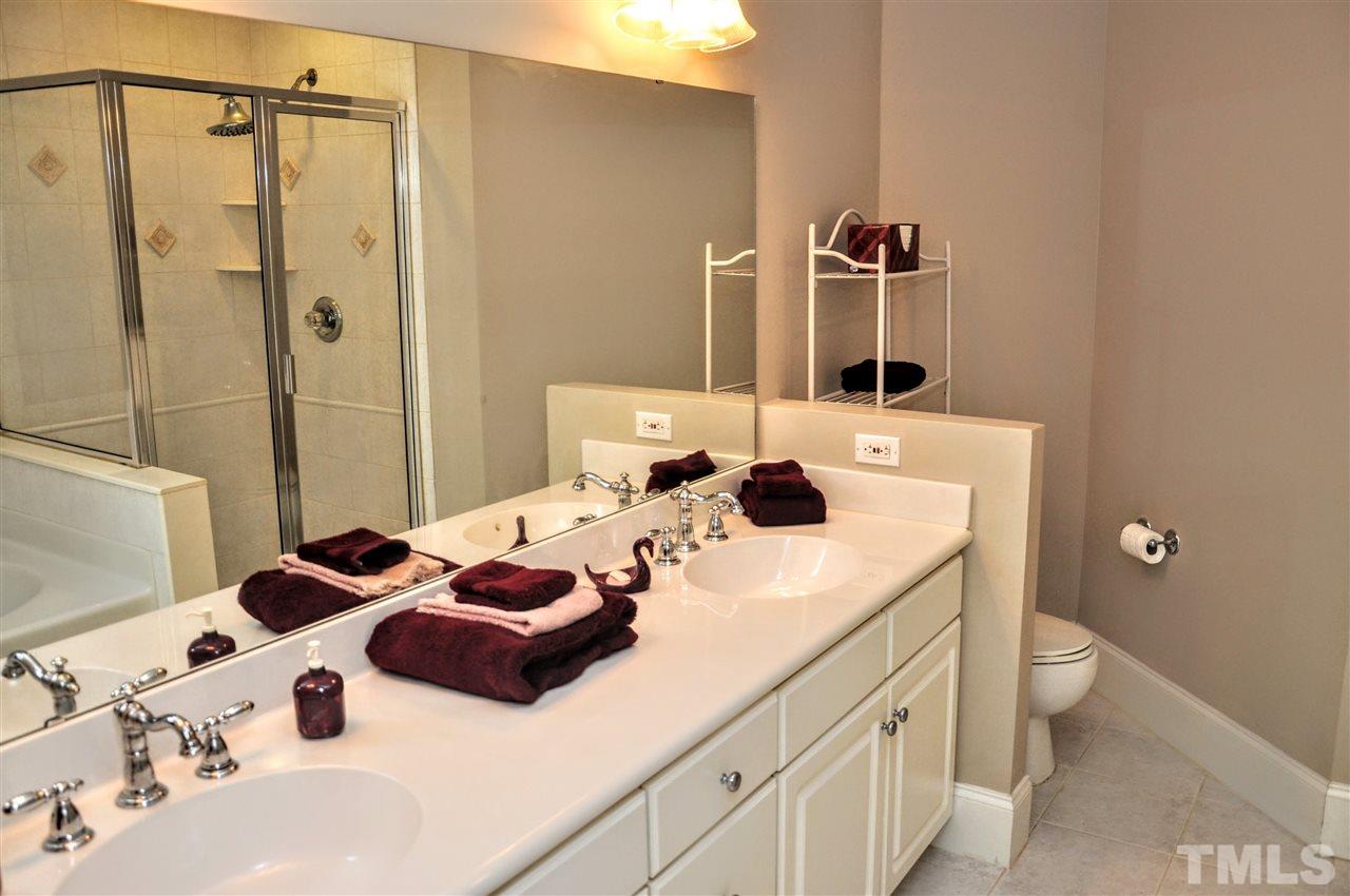 6902 Ray Road Raleigh, NC 27613 - Photo 12 of 23 a bathroom with a sink and a mirror