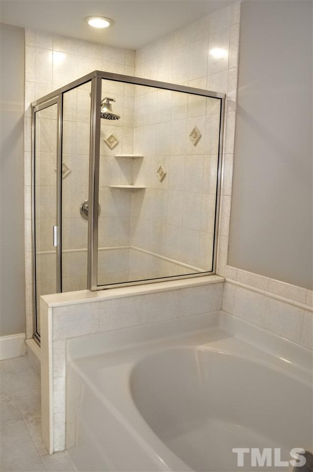 6902 Ray Road Raleigh, NC 27613 - Photo 13 of 23 a bathroom with a shower and a bath tub