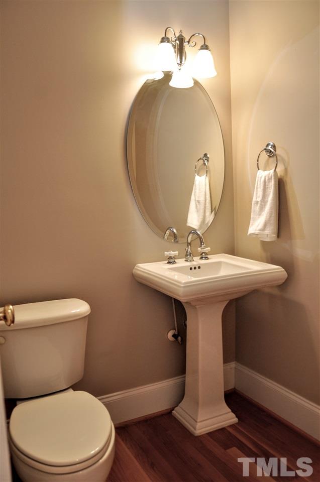 6902 Ray Road Raleigh, NC 27613 - Photo 14 of 23 a bathroom with a toilet sink and mirror
