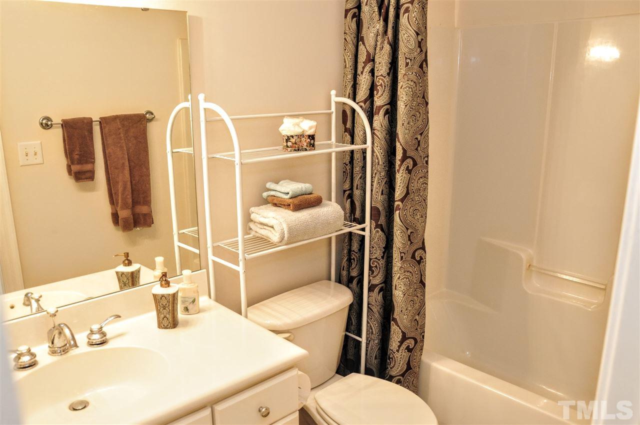 6902 Ray Road Raleigh, NC 27613 - Photo 18 of 23 a bathroom with a sink toilet and shower