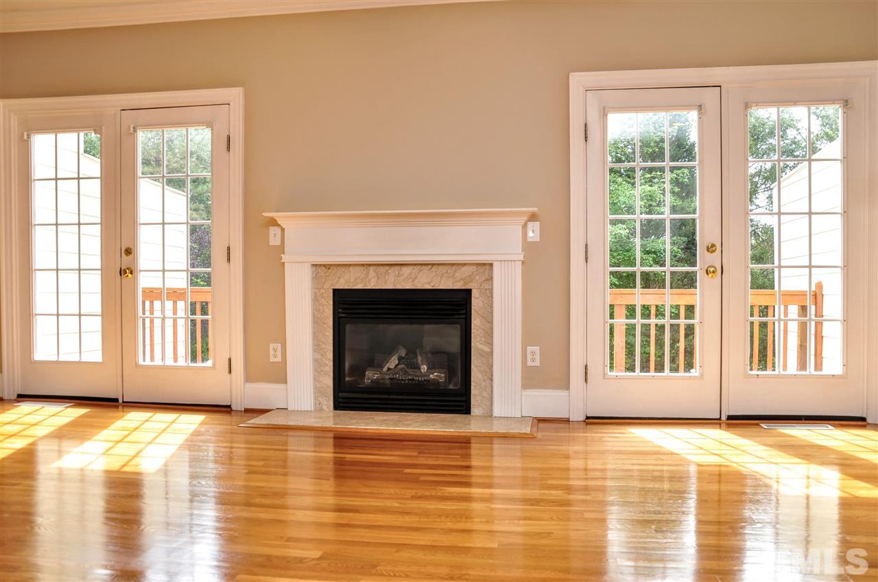 6902 Ray Road Raleigh, NC 27613 - Photo 7 of 23 a view of an empty room with a fireplace and a window