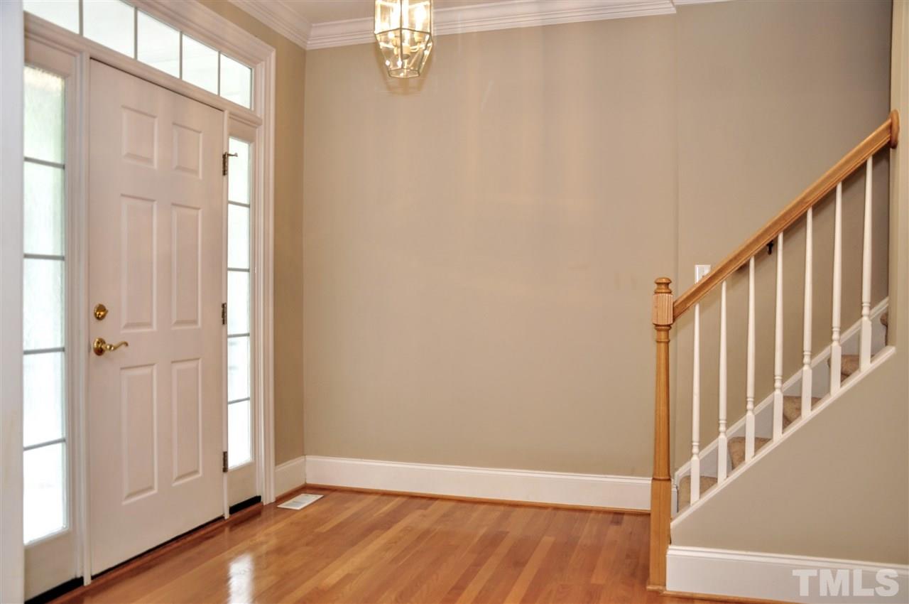 6902 Ray Road Raleigh, NC 27613 - Photo 10 of 23 a view of a hallway with wooden floor and staircase