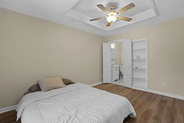a bedroom with a bed and a ceiling fan