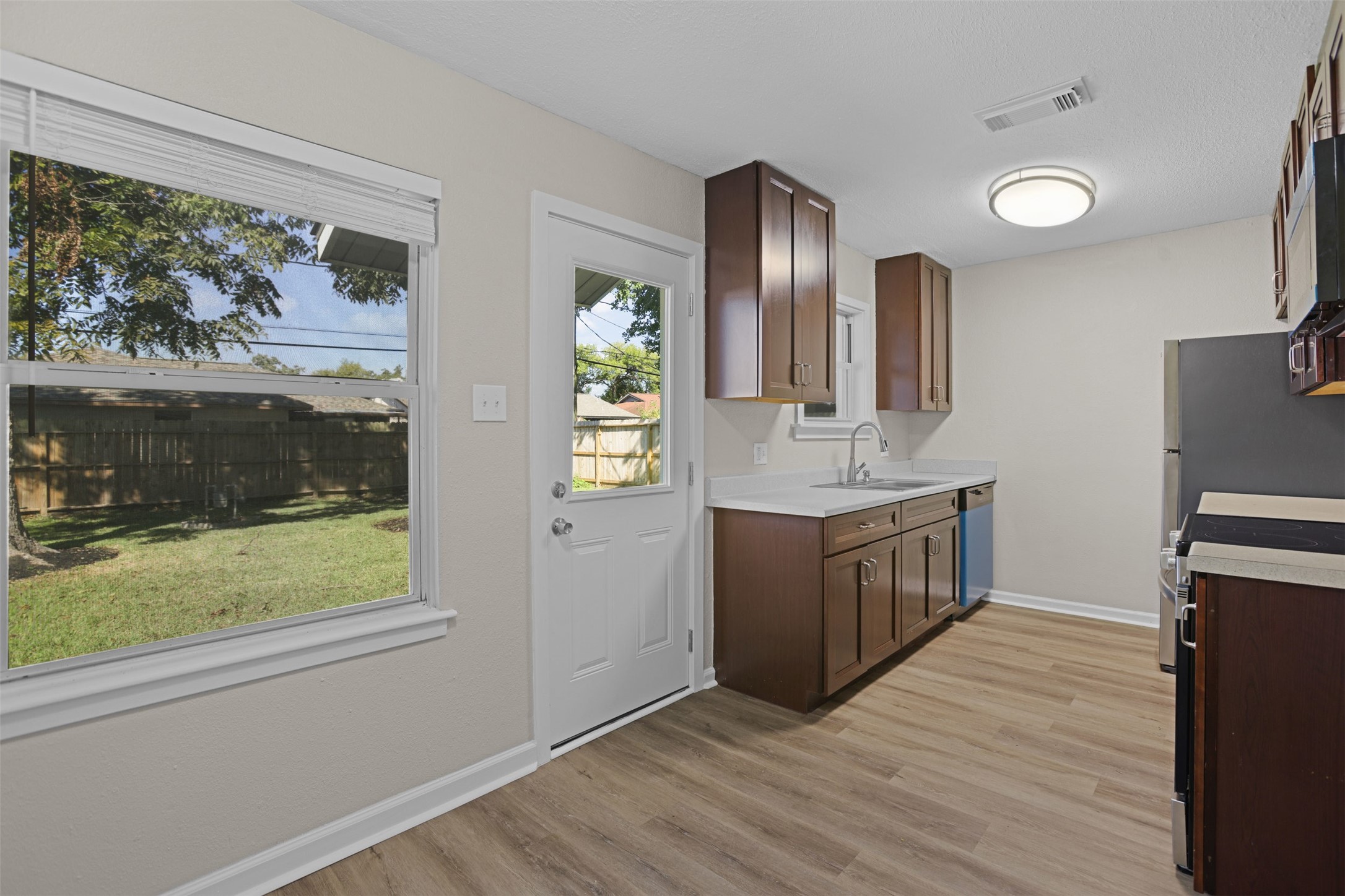 3709 Washington Street Pasadena, TX 77503 - Photo 7 of 22 a kitchen with stainless steel appliances granite countertop a refrigerator a sink a stove and wooden floors