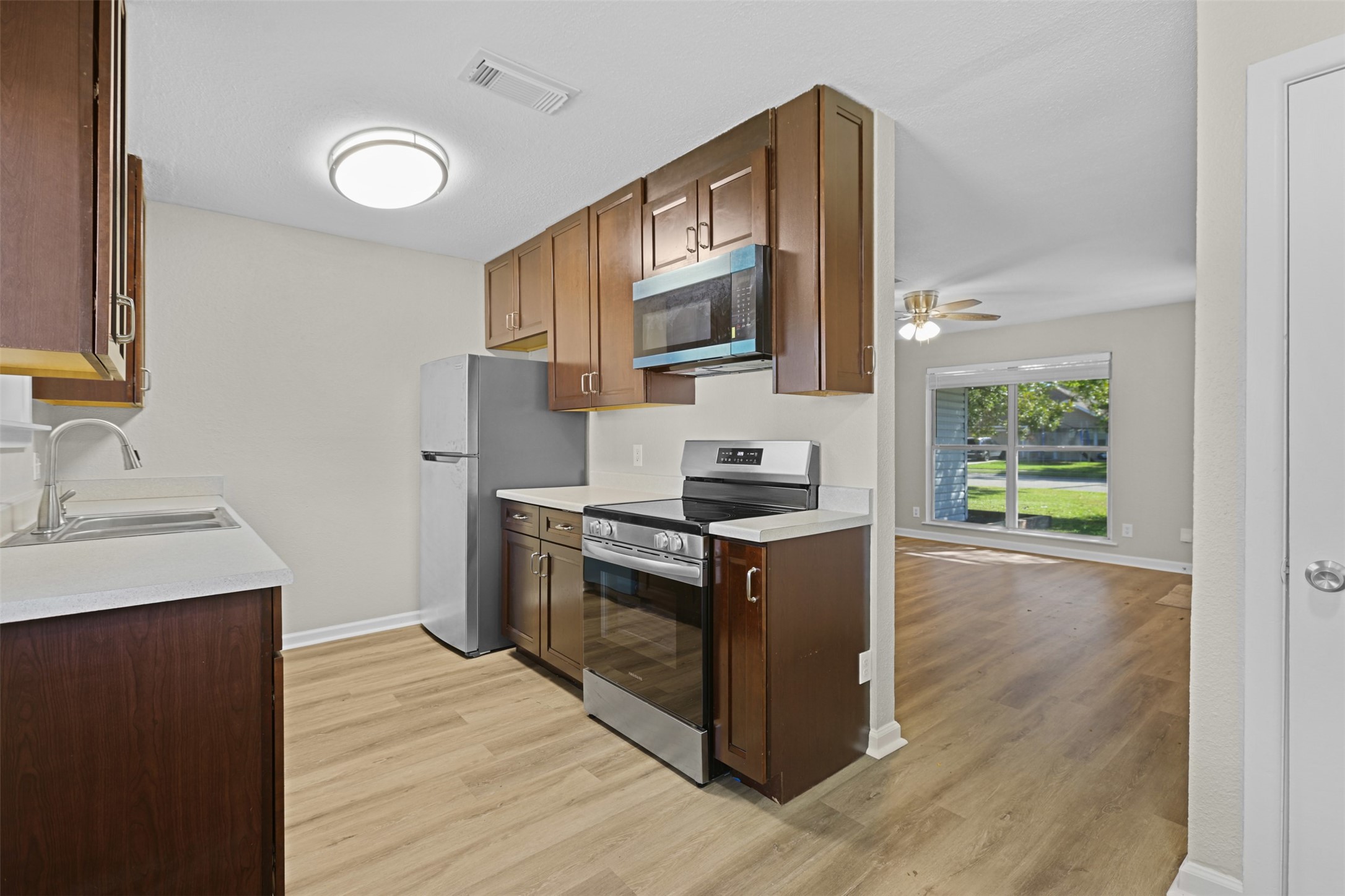 3709 Washington Street Pasadena, TX 77503 - Photo 8 of 22 a kitchen with stainless steel appliances granite countertop a stove and a sink