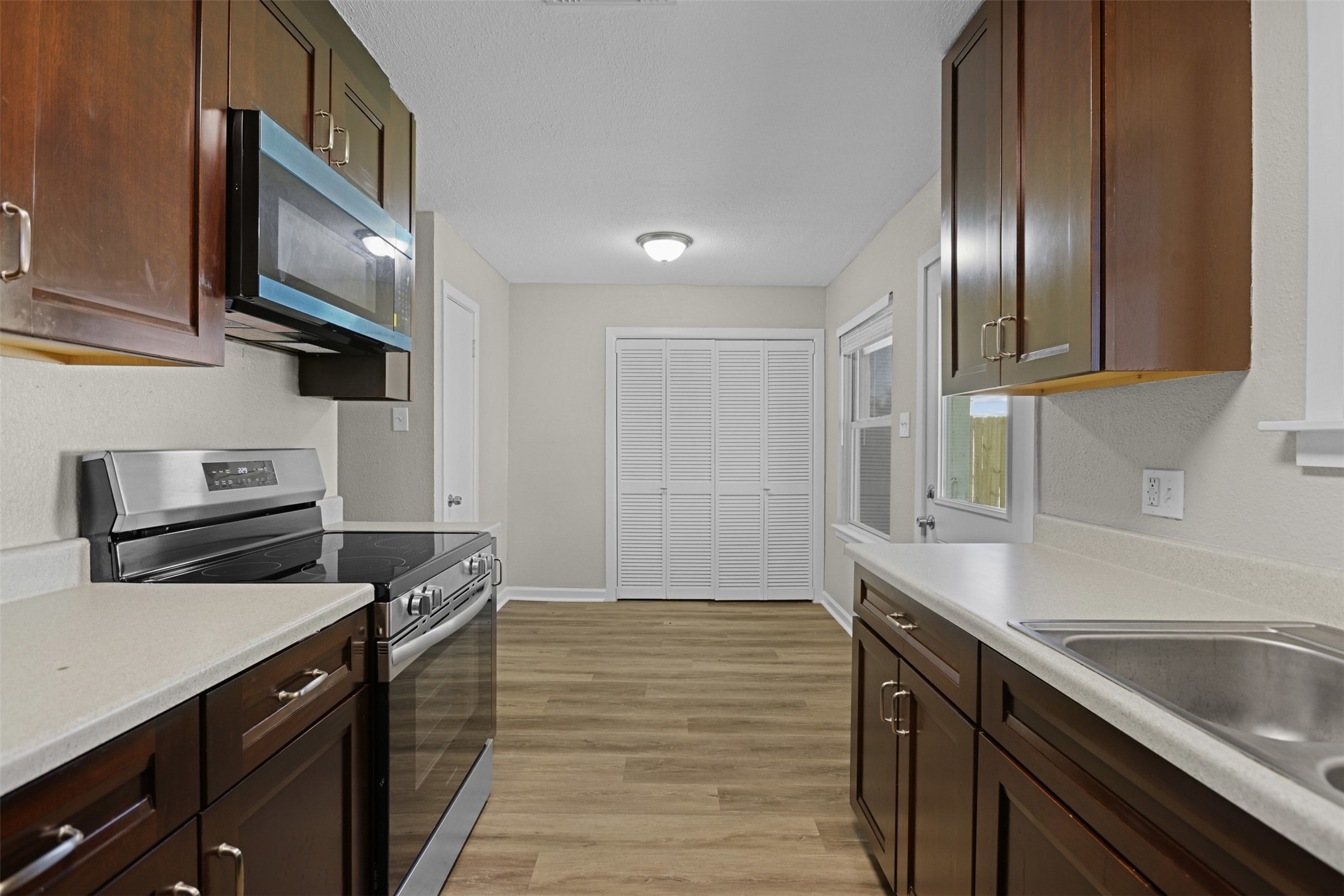 3709 Washington Street Pasadena, TX 77503 - Photo 9 of 22 a kitchen with granite countertop stainless steel appliances and wooden cabinets