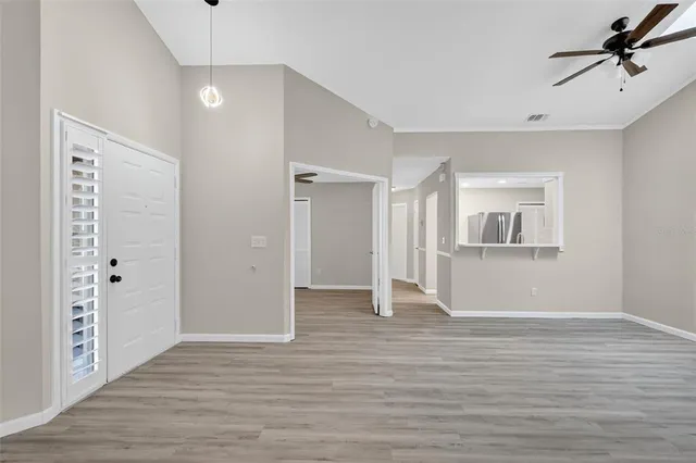 a view of empty room with wooden floor