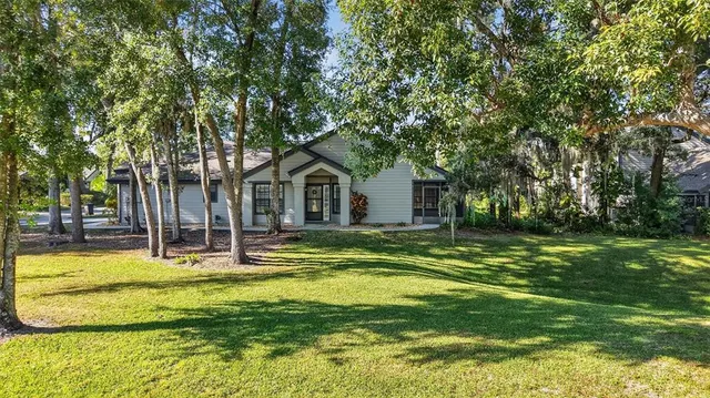 a view of a house with swimming pool and sitting area