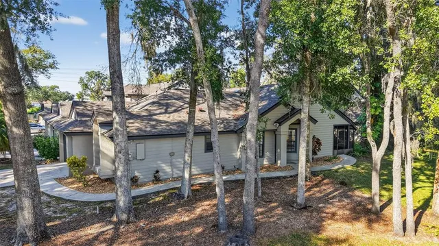 a backyard of a house with table and chairs