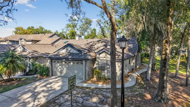 a patio with table and chairs and potted plants