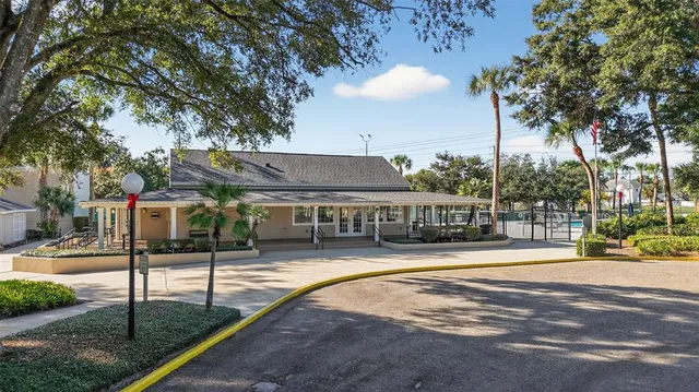 a view of a house with backyard and tree