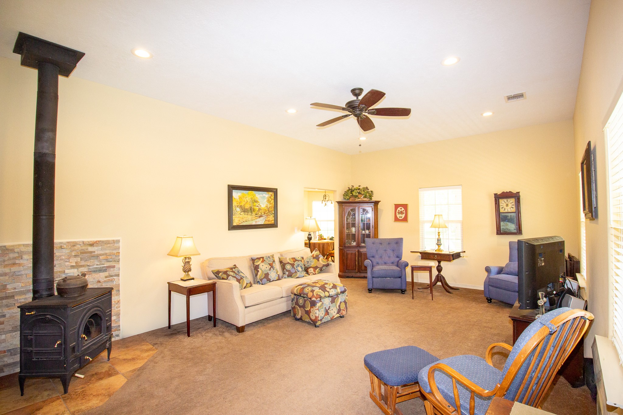 40411 Bosque Road Hempstead, TX 77445 - Photo 13 of 25 Cozy wood-burning cast iron heater paired with a ready supply of seasoned firewood, perfect for warmth, charm, and rustic comfort.