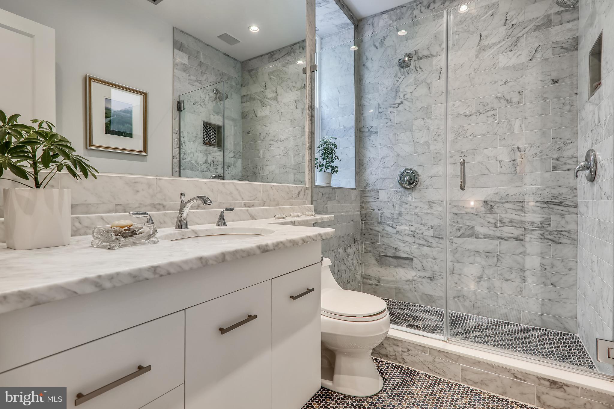 2022 Columbia Road Northwest, Unit 112 Washington, DC 20009 - Photo 28 of 41 Bath w/ Carrera marble and glass dual shower